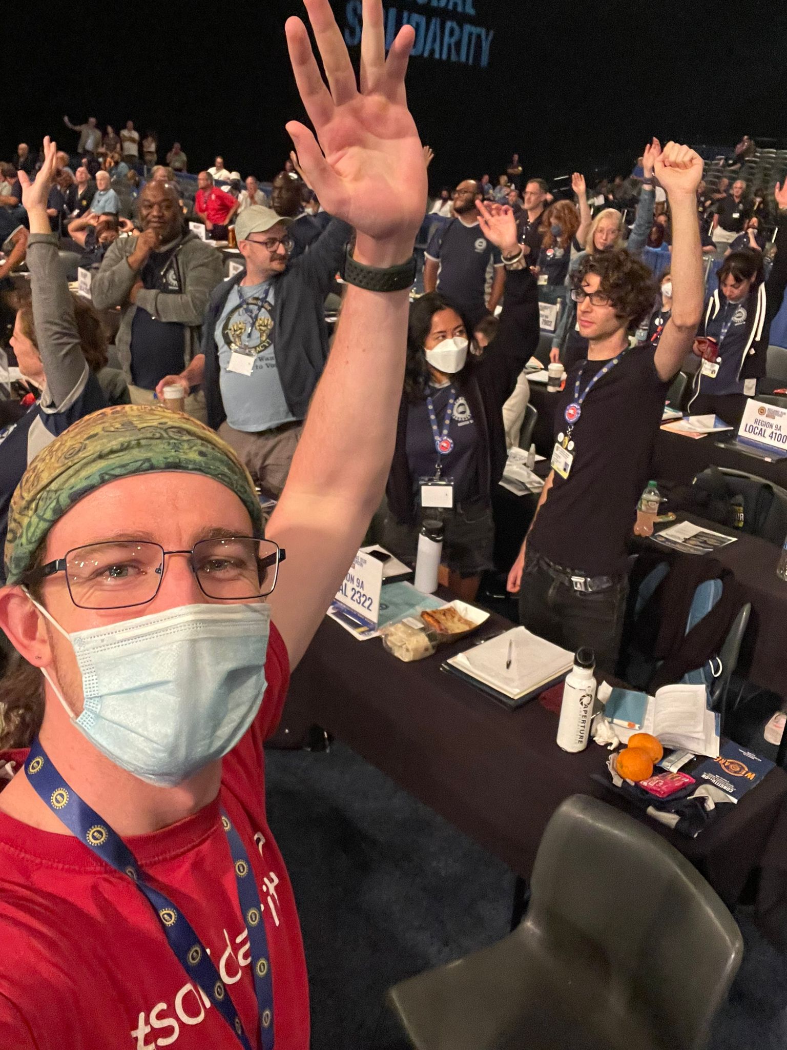 Picture of delegates voting on the floor.